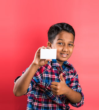 Indian Kid Holding White Card, Indian Boy And Card, Indian Kid Or Indian Boy With White Card Or Banner, Red Background, Smart Boy, Asian Boy Showing White Empty Card