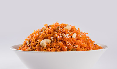tasty gajar halwa or gajar ka halwa made up or fresh carrot, sugar and milk. decorated with almond or badam, cashewnuts and pistachios, favourite north indian dessert usually served in weddings - obrazy, fototapety, plakaty