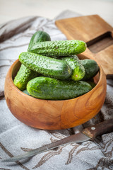 Fresh cucumbers in a wooden bowl.