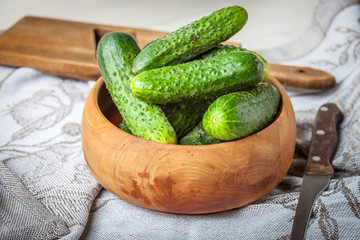 Fresh cucumbers in a wooden bowl.