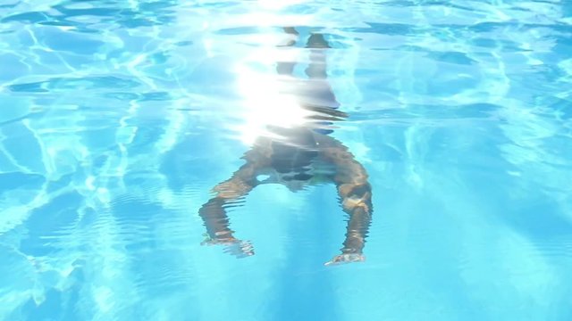 young man swimming underwater in the pool, Slow Motion