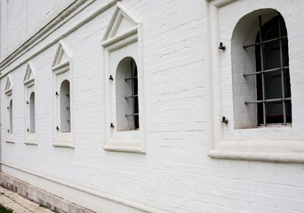 Fototapeta premium Barred windows in white brick wall