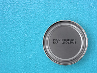 manufacture date and expiry date printed on the bottom of aluminum cans on blue concrete kitchen counter floor, Information of for consumer, top view with copy space