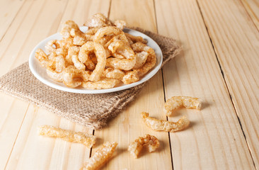 Pork rind junk food snack in white plate
