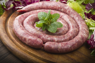 raw homemade sausage on a wooden board