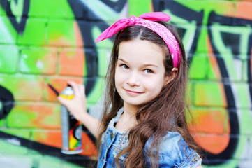 kid girl  near the graffiti wall.