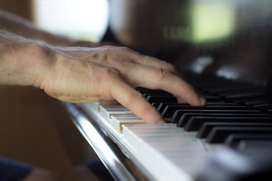 Hands Playing Piano With a Narrow Field of Focus