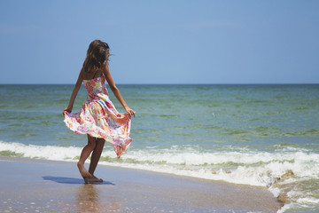 happy and beautiful young woman on sea coast (stylization birth