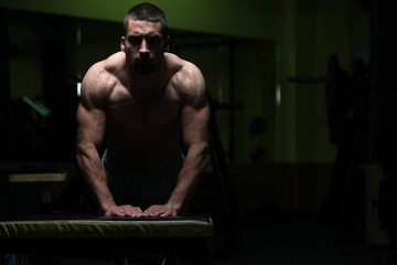 Pushups On Bench In A Dark Room