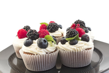 Elegant Cupcakes with Berries on the Black Plate