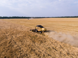 air shot of harvester on the wheat field