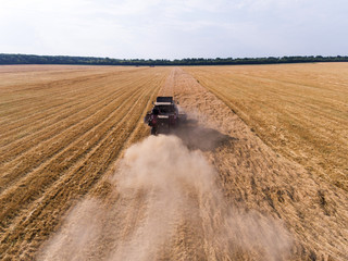 Naklejka premium air shot of harvester on the wheat field