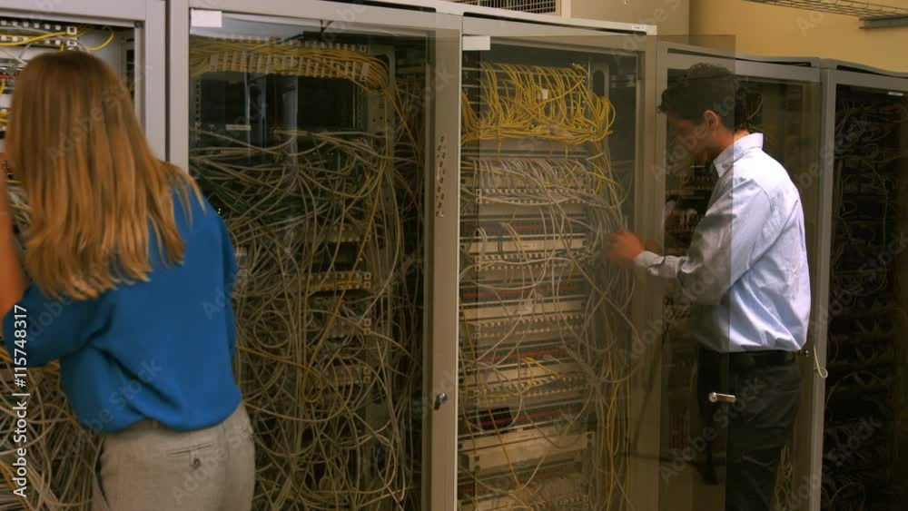 Poster Technicians looking at open server locker
