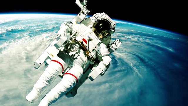 Astronaut in outer space against the backdrop of the planet earth. Elements of this image furnished by NASA.