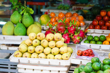 Asian farmer market selling mango and dragon fruit in Vietnam