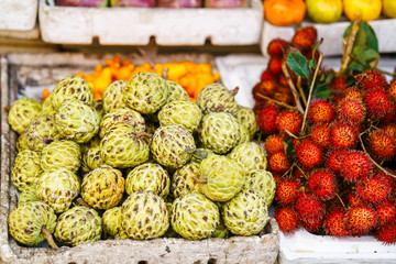 Asian street farmer market selling Cherimoya and rambutan in Vietnam