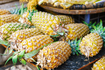 Asian street farmer market selling fresh ananas in Vietnam