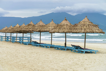 Palm shelters and sun beds in the China Beach