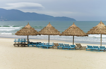 Palm shelters and sunbeds in the China Beach