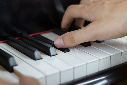 Close up of hands playing piano