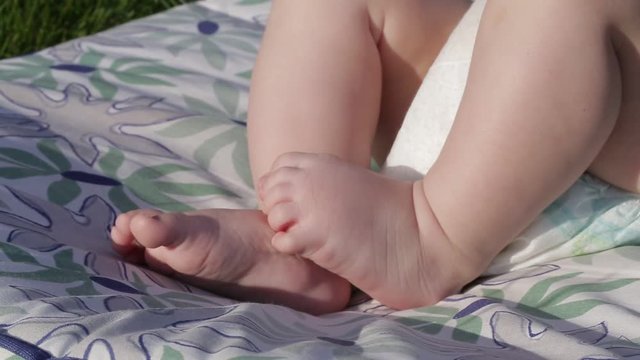 small baby's cute feet on the grass