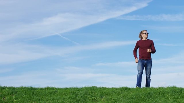 4K Attractive male stops to take in the view before continuing, in slow motion - space for text