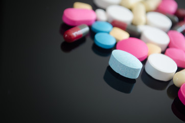 Pharmacy background on a wood table.Pills. Medicine and healthy. Close up of capsules. Different kind of medicines