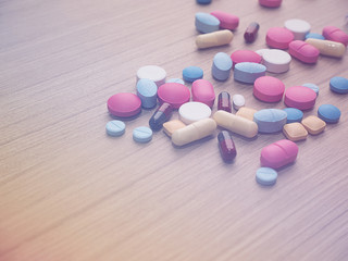 Pharmacy background on a wood table.Pills. Medicine and healthy. Close up of capsules. Different kind of medicines,Color Filter