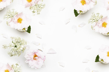 Flowers on white background. Flat lay. Mock-up desk. Beauty 