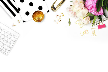 Woman modern background. Flat lay. Flower on the table. Keyboard and stapler. Home workplace. Table view. Business accessories. Mock-up background. Peonies. Glamour style.