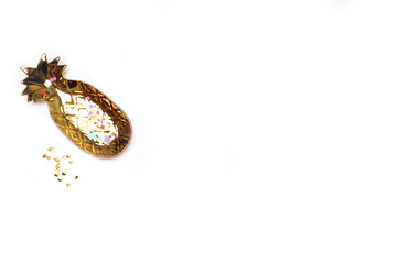 White mock up background, flat lay. Gold pineapple. View up. Feminine scene, workspace. Party background. Female