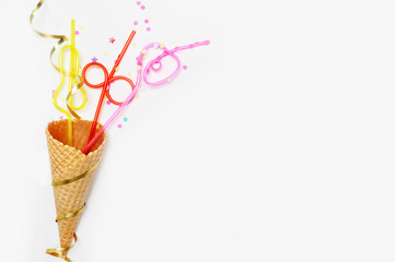 Waffle cone and tubes for cocktails on a white background, festive. Party background. flat lay