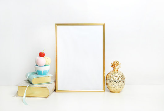 gold picture frame with decorations. Mock up for your photo or text Place your work, print art,shabby style, white background, pastel color book, gold pineapple