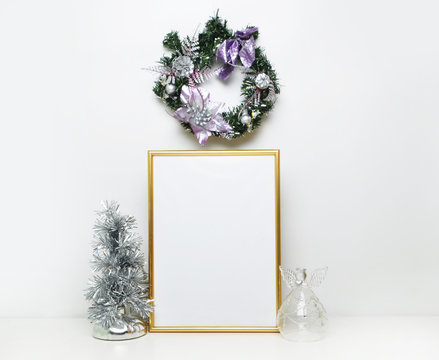 gold picture frame with xmas decorations. Mock up for your photo or text Place your work, print art,white background, angel and fir-tree