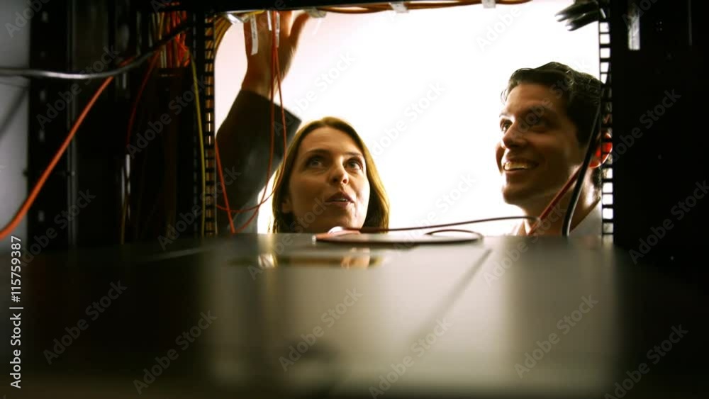 Poster Technicians looking at open server locker