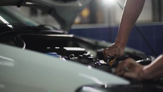 Auto mechanic repair engine in a car repair shop