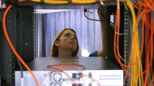 Technician looking at open server locker
