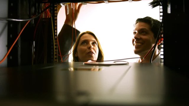 Technicians looking at open server locker
