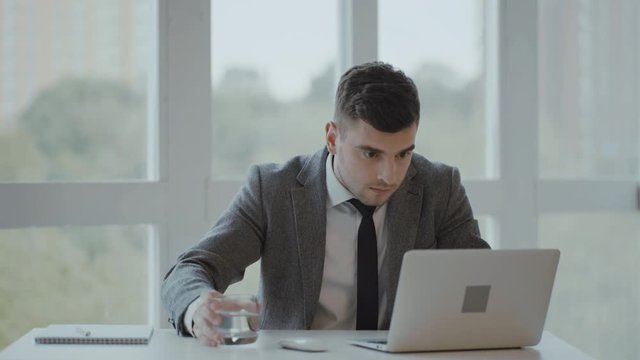 Young businessman gets bad news in office