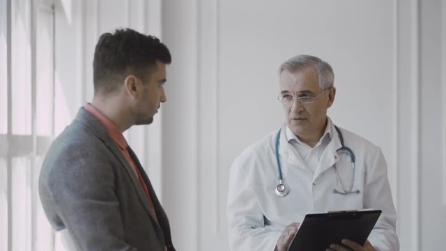 Senior doctor consults young patient