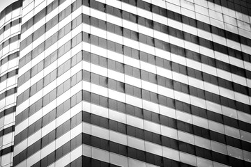 windows of business building on black and white color
