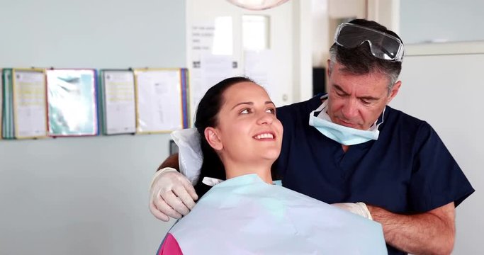 Dentist speaking with his patient 