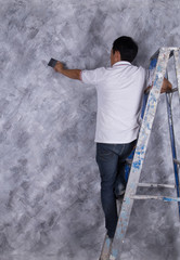 worker use brush for color paint concrete Loft style on wall