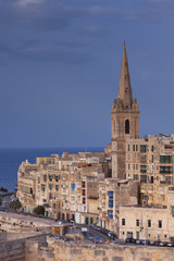 Bell tower of Basilica of Our Lady of Mount Carmel on a sky blue day 