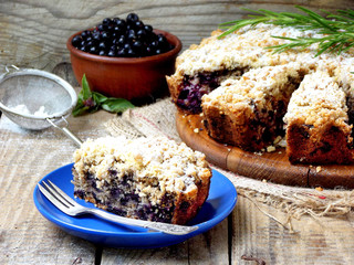 Homemade blueberries crumble pie on a wooden background