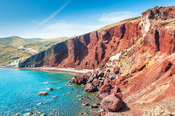 Fototapeta na wymiar Beautiful Red Beach with turquoise water and big rocks