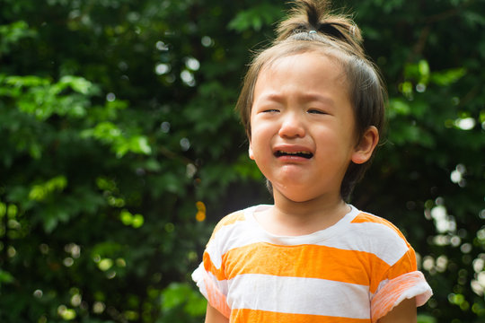 Asian baby boy crying in the garden
