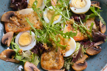 warm salad with chicken breast, mushrooms, egg and fresh arugula.