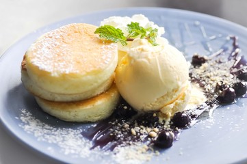 pancake and vanilla ice cream with blueberry sauce