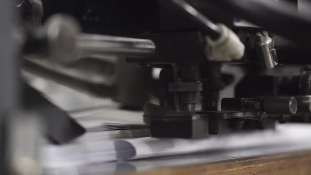 Printing house: Machine working in printing house. Footage with sound. Close up, 4K.